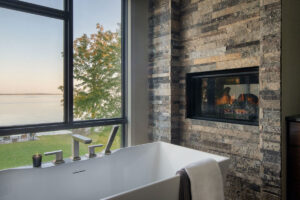 close up of bathtub with fireplace in bathroom